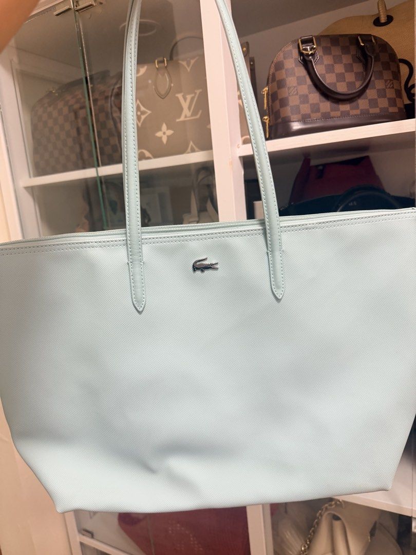 Lacoste Light Blue Tote Bag (Category: Tote Bags) located in Manila. Submitted by carlajoyce (Listing ID 1468882922, Image 1). Description: - Brand: Lacoste - Color: Light Blue - Material: Durable textured PVC - Design: Dual shoulder straps with center metal crocodile logo - Closure: Secure zip top - Best for: Work, school, and daily errands - Condition: Excellent and clean shape From Us Guarantee Origianl.