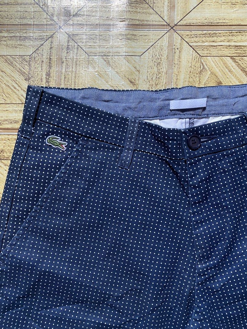 Lacoste Live Polka Dot Short (Category: Shorts) located in Manila. Submitted by tygaangub1096 (Listing ID 1468883392, Image 2). Description: - Brand: Lacoste Live - Size: US 30 / French 38 20 length - Color: Dark blue with white polka dots - Closure: Button with zipper fly - Pockets: Two front slant pockets and two back welt pockets - Details: Small embroidered crocodile logo on the front right and chambray interior trim - Condition: Excellent - 