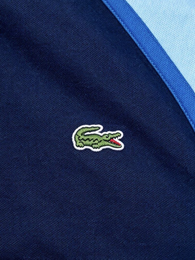Lacoste Men’s Polo Shirt (Category: Tshirts & Polo Shirts ) located in Taguig. Submitted by amboyfiggah (Listing ID 1468848089, Image 2). Description: Lacoste Men’s Color-block Navy blue center chest & light blue sleeves and collar. L on tag Fits M to L W: 22.5 L: 27 Excellent condition Color rate: 9.5/10 Flawless Issue: minimal bleach stain back in collar .