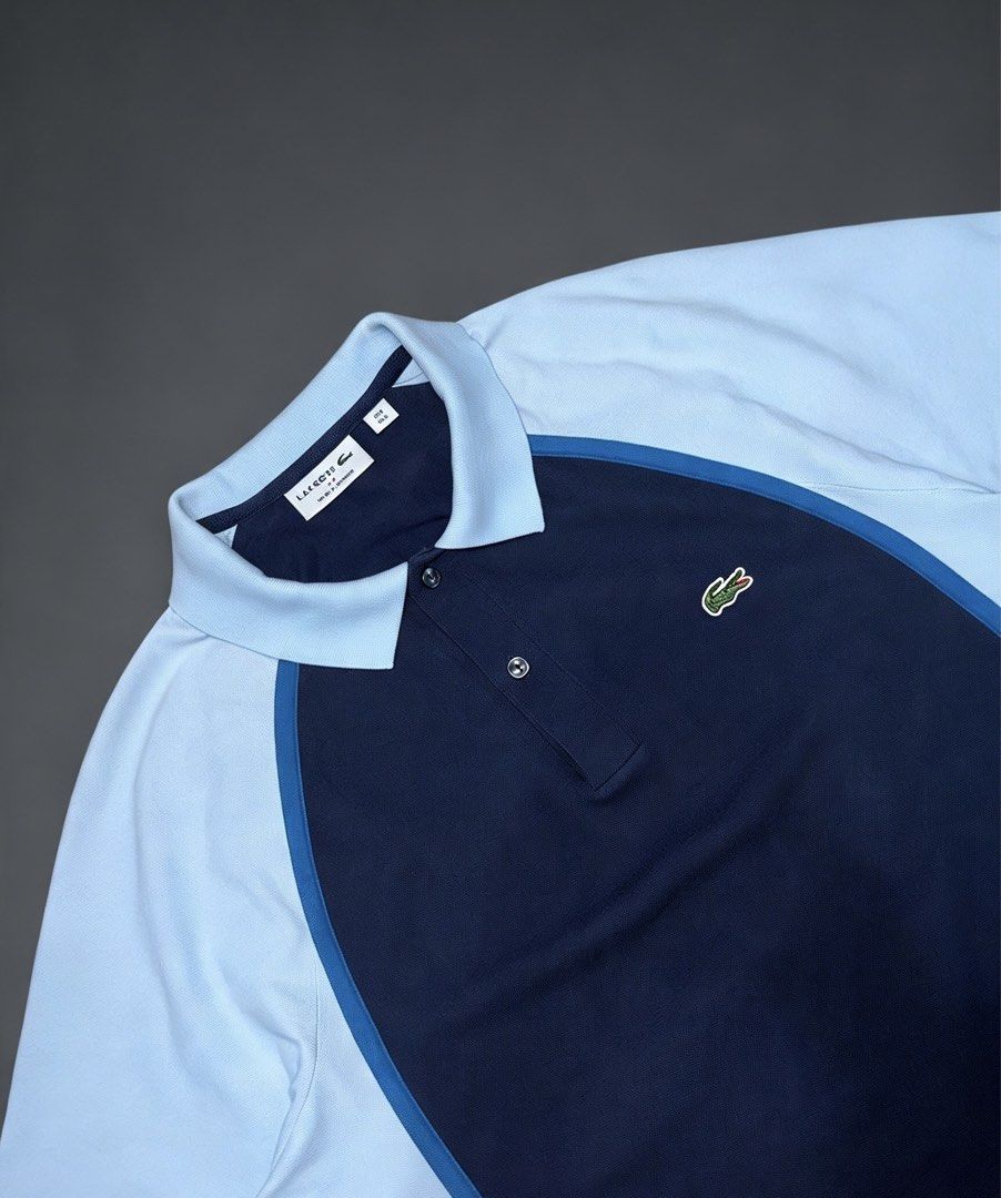 Lacoste Men’s Polo Shirt (Category: Tshirts & Polo Shirts ) located in Taguig. Submitted by amboyfiggah (Listing ID 1468848089, Image 3). Description: Lacoste Men’s Color-block Navy blue center chest & light blue sleeves and collar. L on tag Fits M to L W: 22.5 L: 27 Excellent condition Color rate: 9.5/10 Flawless Issue: minimal bleach stain back in collar .