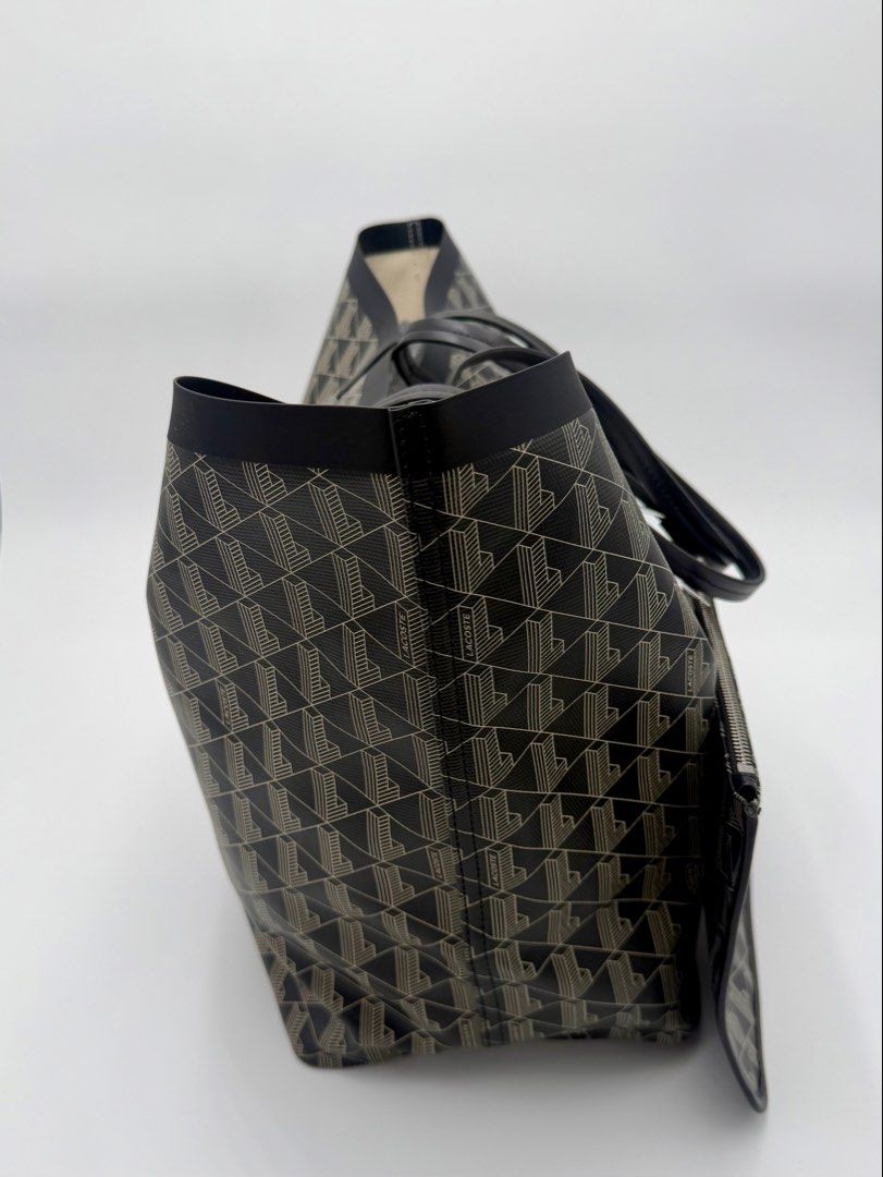 Lacoste Monogram Tote Bag with Pouch (Category: Tote Bags) located in Manila. Submitted by mrjalandoni (Listing ID 1468762051, Image 2). Description: - Brand new Lacoste tote bag with original store tags attached - Chic dark navy and cream all-over monogram pattern - Includes a convenient matching zippered pouch - Designed with comfortable double shoulder handles - Spacious interior perfect for everyday use.