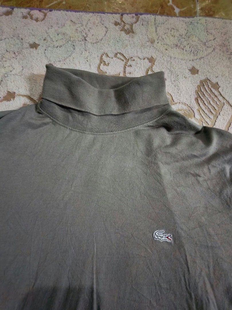 Lacoste Olive Green Long Sleeve Turtleneck (Category: Coats, Jackets and Outerwear) located in Sipalay. Submitted by boldowl.e4f283 (Listing ID 1468773078, Image 2). Description: Olive green Lacoste turtleneck sweater. Long sleeves, classic high collar. Small embroidered crocodile logo on the left chest. 100% cotton material. Size 100 tag inside. Ribbed neck and cuffs. Clean fabric texture, standard casual wear..