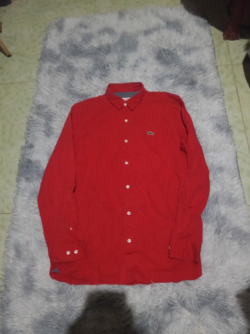 Lacoste Red Long Sleeve Button-Up Shirt (Category: Tshirts & Polo Shirts ) located in Lingayen. Submitted by rahzzelula73279 (Listing ID 1468725836, Image 1). Description: - Brand: Lacoste - Style: Long sleeve button-up shirt (Style CH4654) - Color: Bright red with white buttons and classic embroidered crocodile logo - Material: 100% premium cotton - Size: 39 (Equivalent to US 15.5 or Medium) - Condition: Clean, excellent, .