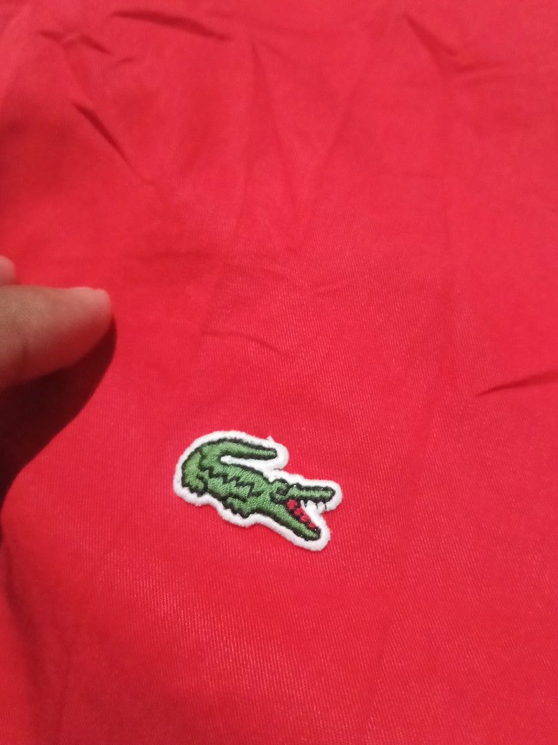 Lacoste Red Long Sleeve Button-Up Shirt (Category: Tshirts & Polo Shirts ) located in Lingayen. Submitted by rahzzelula73279 (Listing ID 1468725836, Image 2). Description: - Brand: Lacoste - Style: Long sleeve button-up shirt (Style CH4654) - Color: Bright red with white buttons and classic embroidered crocodile logo - Material: 100% premium cotton - Size: 39 (Equivalent to US 15.5 or Medium) - Condition: Clean, excellent, .