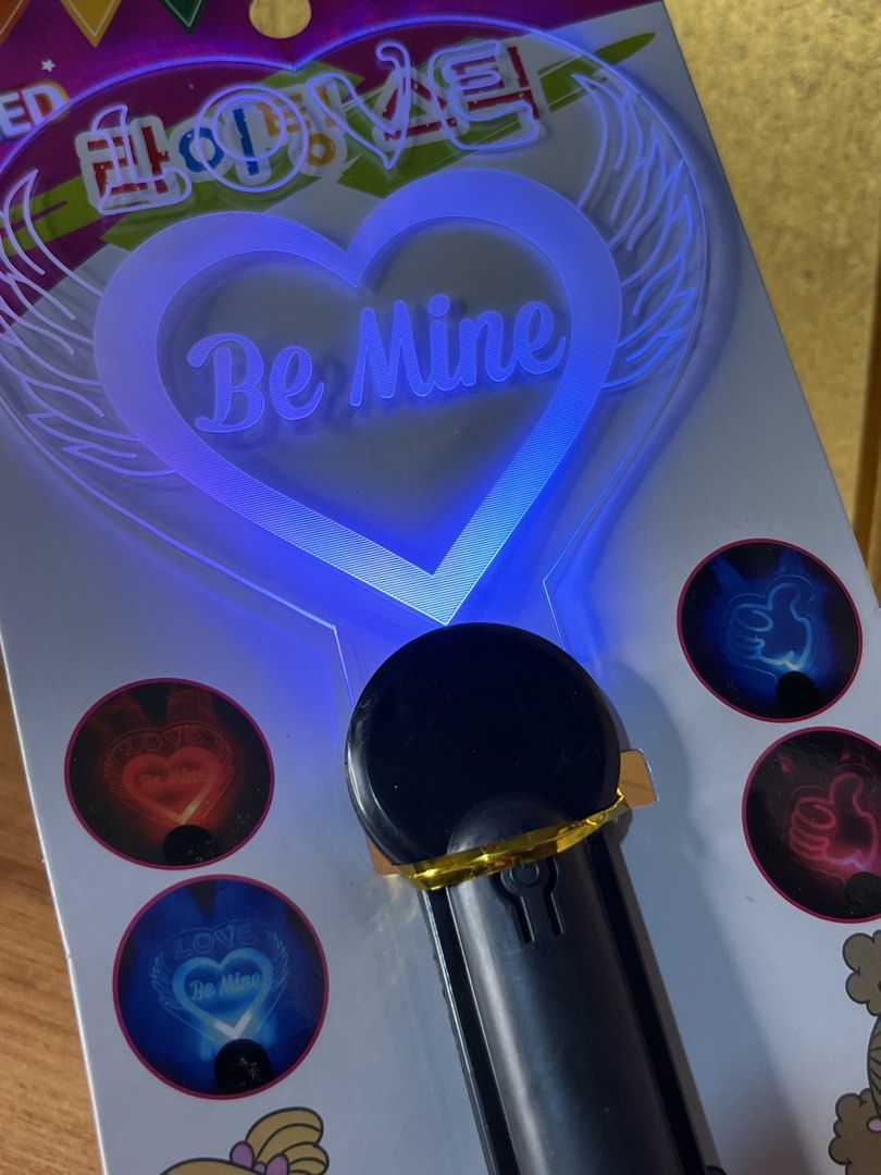 LED Lighting Stick Be Mine Heart Glow Wand (Category: Lighting) located in Gapan. Submitted by lunashop14 (Listing ID 1468715348, Image 3). Description: 4 pcs available sealed - Design: Heart-shaped with "Be Mine" text and angel wings - Lighting: Multicolored flashing LED lights - Size: Approximately 115mm x 250mm - Handle: Black plastic with a convenient hanging loop - Condition: Brand new, sealed in original packaging with Korean product label 