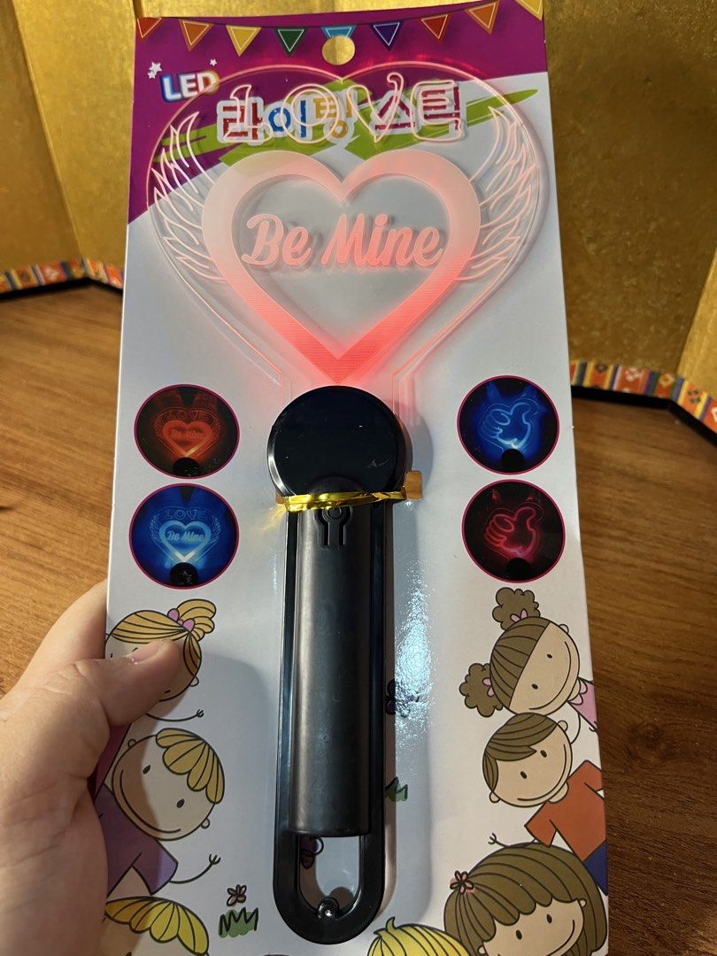 LED Lighting Stick Be Mine Heart Glow Wand (Category: Lighting) located in Gapan. Submitted by lunashop14 (Listing ID 1468715348, Image 2). Description: 4 pcs available sealed - Design: Heart-shaped with "Be Mine" text and angel wings - Lighting: Multicolored flashing LED lights - Size: Approximately 115mm x 250mm - Handle: Black plastic with a convenient hanging loop - Condition: Brand new, sealed in original packaging with Korean product label 