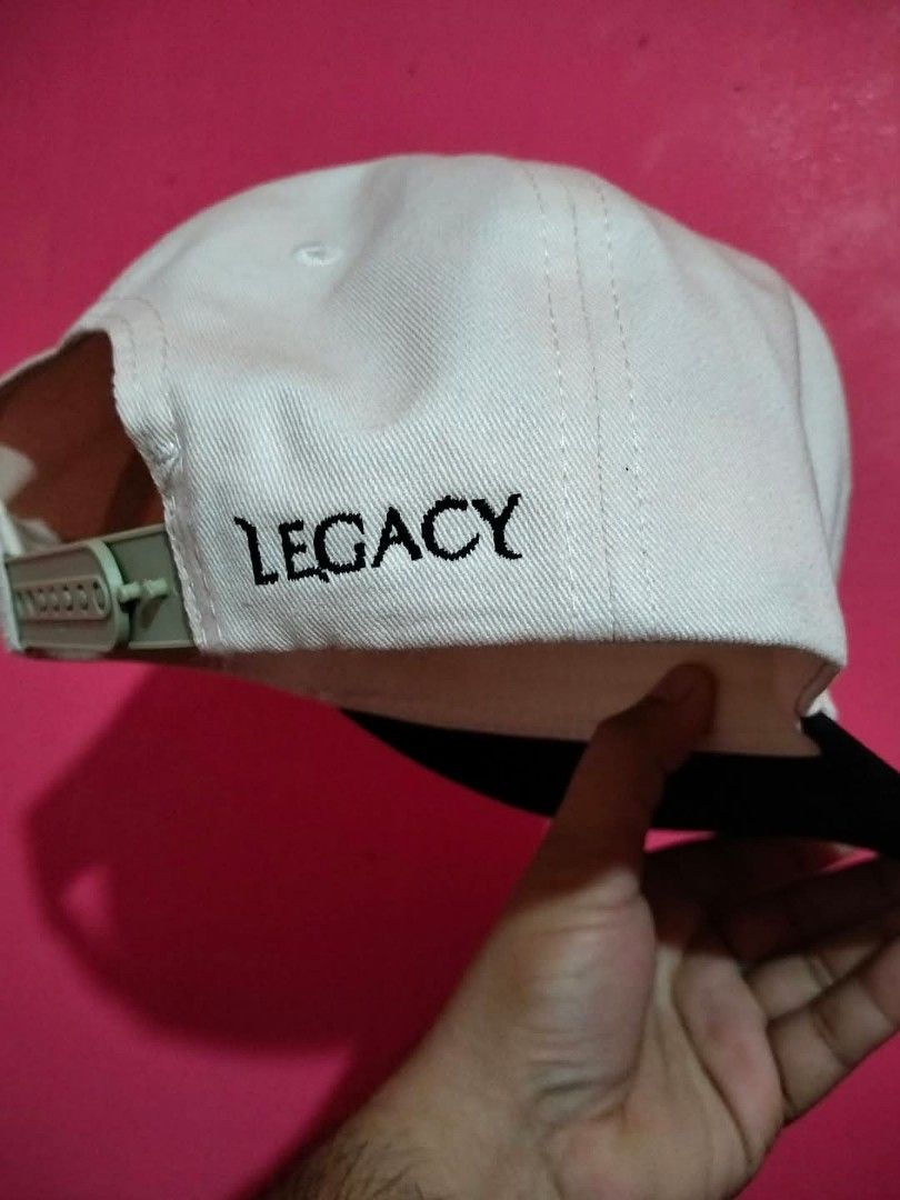 Legacy The Enemy Is Only Good At Lying Snapback Hat (Category: Caps & Hats) located in Mangaldan. Submitted by niftythrifty69 (Listing ID 1468730883, Image 3). Description: - Brand/Model: Legacy snapback hat - Colorway: White crown with contrasting black brim - Design: Bold embroidered front lettering "THE ENEMY IS ONLY GOOD AT LYING" and side branding - Closure: Adjustable green plastic snap closure - Details: Matching white taped seams and prin