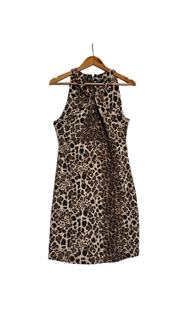 Leopard Print Halter Neck Mini Dress (Category: Dresses) located in Batangas. Submitted by yanaspreloved1 (Listing ID 1468924380, Image 2). Description: - Trendy leopard print mini dress with a fitted silhouette - Halter neckline with a stylish front knot detail - Sleeveless cut, hits above the knee - Secure back zipper closure - Includes a matching leopard print cat ear headband - Perfect for parties, nights out, and costume events.