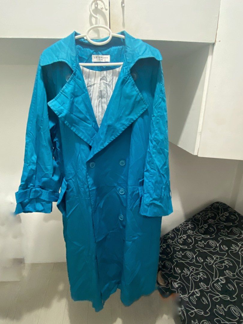 LE-SHERO Bright Blue Double Breasted Trench Coat (Category: Coats, Jackets and Outerwear) located in Manila. Submitted by abbyyey (Listing ID 1468773239, Image 1). Description: - Brand: Le-Shero - Color: Bright blue - Style: Double-breasted trench coat with lapel collar and front buttons - Features: Deep side pockets, long sleeves with cuff strap details - Lining: White fabric with thin grey vertical stripes - Fit: Roomy enough for layering over 
