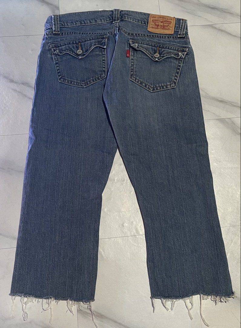 Levi's 542 Low Flare Jeans Size 12M (Category: Jeans) located in Cavite. Submitted by christianzuuu (Listing ID 1468767041, Image 2). Description: Levi's 542 low flare jeans in medium blue wash. Size 12M on tag, with laid-flat measurements handwritten on tape across the back pocket: waist 17 inches, length 32 inches, leg opening 10.5 inches. Button fly closure. Flap pockets on the back with button details. Raw frayed hems at the bottom. 99 percen