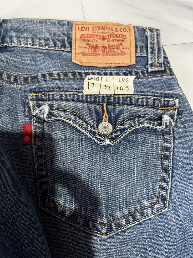 Levi's 542 Low Flare Jeans Size 12M (Category: Jeans) located in Cavite. Submitted by christianzuuu (Listing ID 1468767041, Image 3). Description: Levi's 542 low flare jeans in medium blue wash. Size 12M on tag, with laid-flat measurements handwritten on tape across the back pocket: waist 17 inches, length 32 inches, leg opening 10.5 inches. Button fly closure. Flap pockets on the back with button details. Raw frayed hems at the bottom. 99 percen