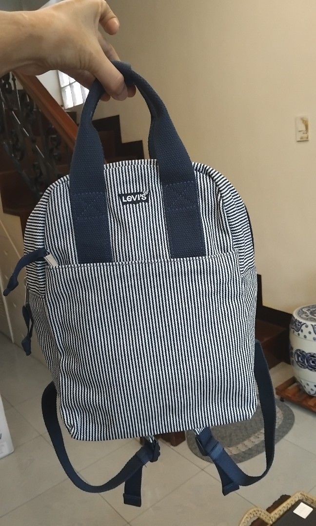 Levi's Blue White Striped Backpack Canvas Bag (Category: Cross-body Bags) located in Naga. Submitted by camsss_f (Listing ID 1468797950, Image 1). Description: - Brand: Levi's - Design: Blue and white striped canvas with signature front branded patch - Storage: Spacious main compartment with zipper closure and front zipped pocket for quick access - Carry: Dark blue top handles and comfortable adjustable shoulder straps - Use: Ideal casual everyda