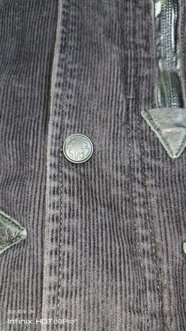 Levi's Corduroy Utility Jacket Grey Black (Category: Coats, Jackets and Outerwear) located in Candaba. Submitted by treblig. (Listing ID 1468713547, Image 3). Description: - Brand: Levi's - Material: Corduroy - Color: Grey and dark tones - Pockets: Multiple zippered front pockets - Details: Logo-stamped snap buttons, structured collar with inner red Levi's label - Fit & Adjustments: Adjustable drawstring hem and velcro cuffs.