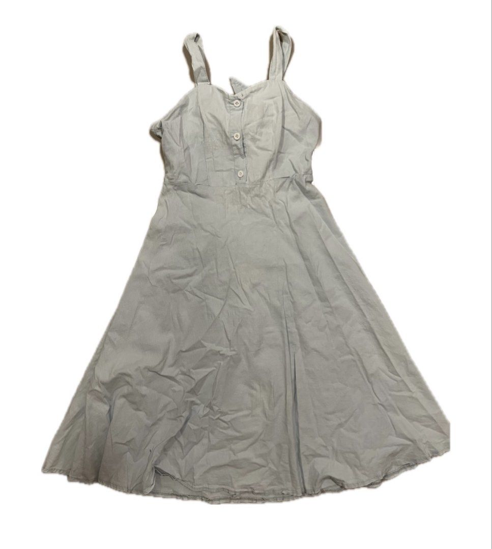 Light blue button-front midi dress with tie back (Category: Dresses) located in Koronadal. Submitted by keenpenguin_6af0c6 (Listing ID 1468814914, Image 1). Description: - Color: Light blue - Length: Midi (mid-calf) - Material: Breezy textured fabric - Design: Sleeveless with thick straps, front button placket with 3 white buttons, and a defined waist - Back Details: Cutout with a tied strap accent and elasticated waistband gathering - Style: Fla