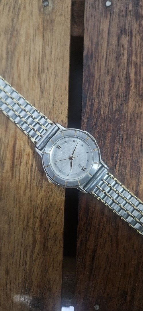 Lighthouse Two-Tone Analog Watch With Roman Numerals (Category: Women's Watches) located in Santa Maria. Submitted by rommelmateo (Listing ID 1468860512, Image 1). Description: - Brand: Lighthouse - Movement: Battery-operated quartz movement for reliable timekeeping - Design: Two-tone silver and gold strap with mixed metal aesthetic - Dial: Textured silver dial featuring Roman numerals at twelve and six - Bezel: Round bezel accented with metallic