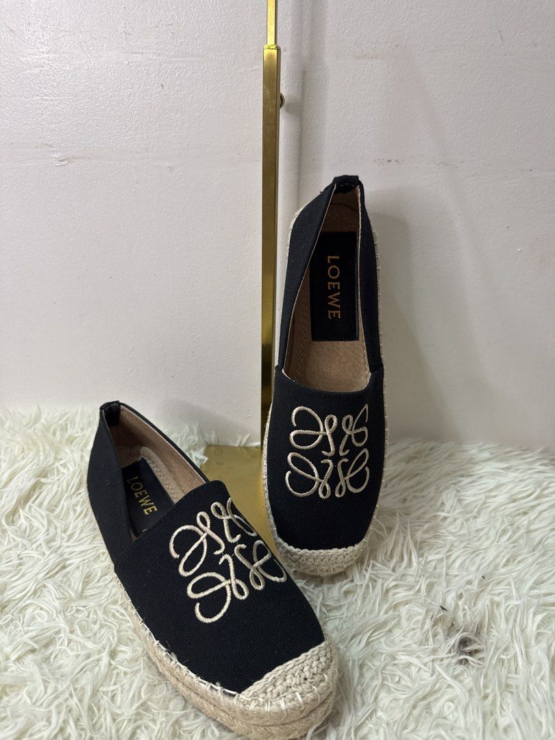Loewe Black Canvas Anagram Espadrilles Size 40 (Category: Flats & Sandals) located in Consolacion. Submitted by naome1. (Listing ID 1468876737, Image 2). Description: - Brand: Loewe - Style: Black canvas slip-on espadrilles - Size: EU 40 - Design: Beige embroidered Anagram logo on top - Sole: Jute braided with textured rubber bottom - Interior: Clean lining with gold branding - Condition: Great everyday footwear option, well-maintained.