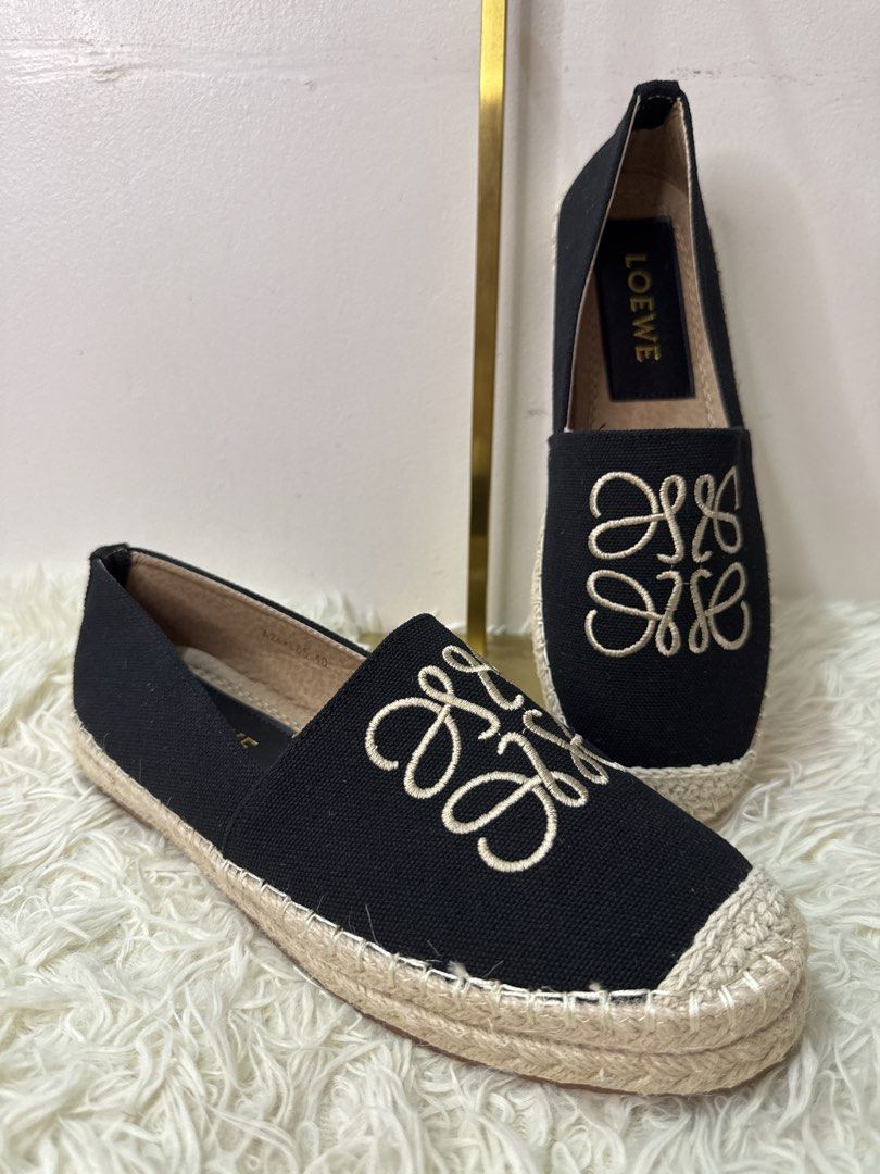 Loewe Black Canvas Anagram Espadrilles Size 40 (Category: Flats & Sandals) located in Consolacion. Submitted by naome1. (Listing ID 1468876737, Image 3). Description: - Brand: Loewe - Style: Black canvas slip-on espadrilles - Size: EU 40 - Design: Beige embroidered Anagram logo on top - Sole: Jute braided with textured rubber bottom - Interior: Clean lining with gold branding - Condition: Great everyday footwear option, well-maintained.
