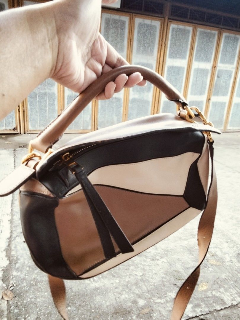 Loewe Puzzle Bag Multi-colour Leather (Category: Luxury Bags & Wallets) located in Tuguegarao City. Submitted by luxthrifttuguegarao (Listing ID 1468766359, Image 1). Description: -Loewe Puzzle bag in a stylish multi-colour leather block design - Features a top handle and a convenient adjustable shoulder strap - Elegant gold-tone hardware with Loewe branding stamps - Interior lined with durable herringbone canvas - Includes 'Made in Spain' tag an