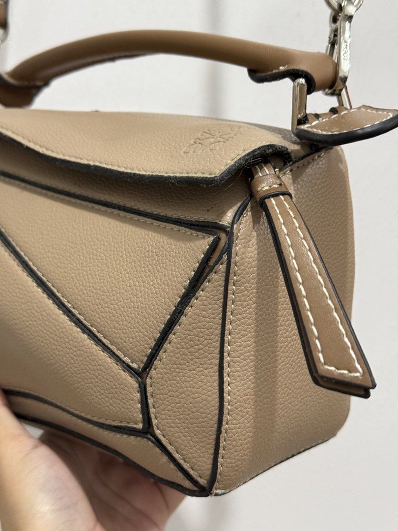 Loewe Puzzle Bag Tan (Category: Luxury Bags & Wallets) located in Makati City. Submitted by vvandko (Listing ID 1468879890, Image 3). Description: Condition: Used only a couple of times. Has a small dark mark on the top flap near the edge, which may come off with proper cleaning. Authenticity: Not guaranteed..
