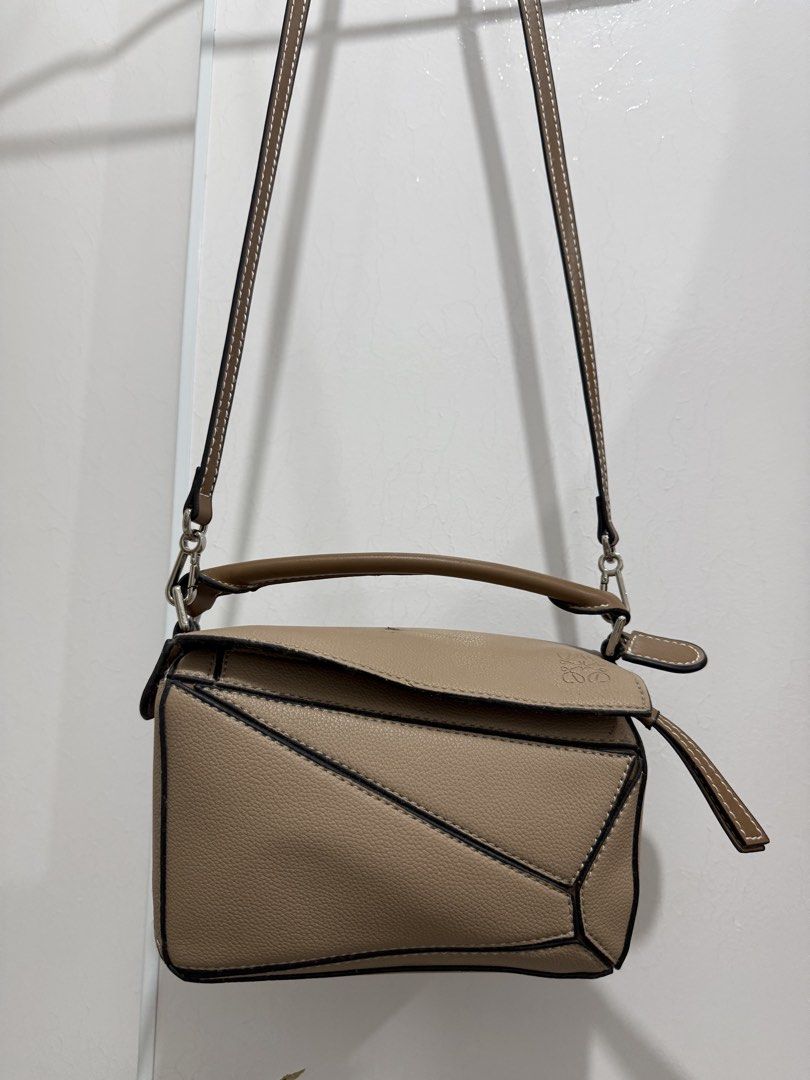 Loewe Puzzle Bag Tan (Category: Luxury Bags & Wallets) located in Makati City. Submitted by vvandko (Listing ID 1468879890, Image 1). Description: Condition: Used only a couple of times. Has a small dark mark on the top flap near the edge, which may come off with proper cleaning. Authenticity: Not guaranteed..
