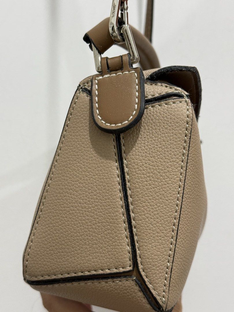Loewe Puzzle Bag Tan (Category: Luxury Bags & Wallets) located in Makati City. Submitted by vvandko (Listing ID 1468879890, Image 2). Description: Condition: Used only a couple of times. Has a small dark mark on the top flap near the edge, which may come off with proper cleaning. Authenticity: Not guaranteed..