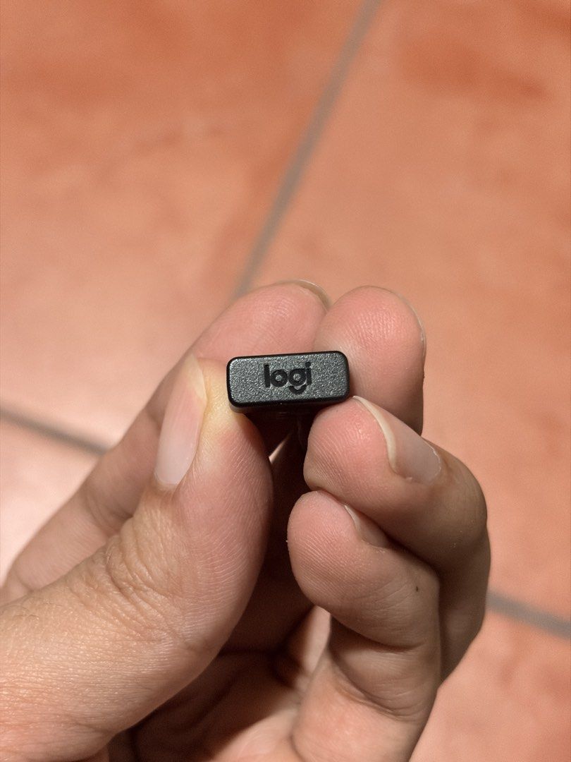 Logitech Unifying USB Receiver (Category: Cables & Adaptors) located in Manila. Submitted by knightto2112 (Listing ID 1468863375, Image 2). Description: - Authentic Logitech Unifying USB receiver with the iconic orange asterisk logo - Model: C-U0007 (S/N LZ327A5A-DJ) - Ideal replacement for lost or broken wireless dongles - Compatible with various Logitech mice and keyboards that support the Unifying protocol - Plug-and-play ready and works perfe