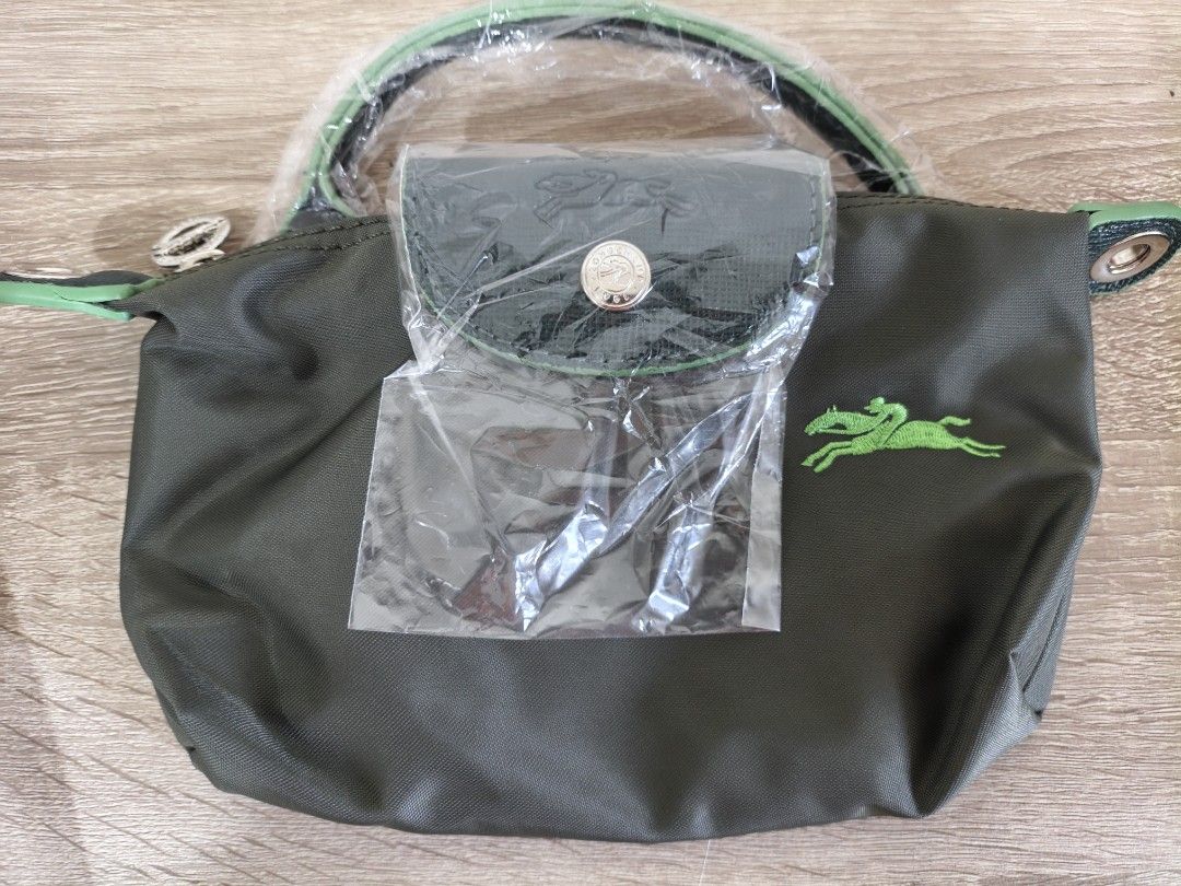 Longchamp Green Nylon Mini Top Handle Bag (Category: Luxury Bags & Wallets) located in Quezon City. Submitted by closeta38 (Listing ID 1468725165, Image 1). Description: - Brand: Longchamp - Color: Olive green nylon with dark green leather flap, handles, and strap - Condition: Brand new (handles still wrapped in protective plastic) - Hardware: Silver-tone with round metal zipper pull - Features: Iconic embroidered horse logo, secure zip closure, 
