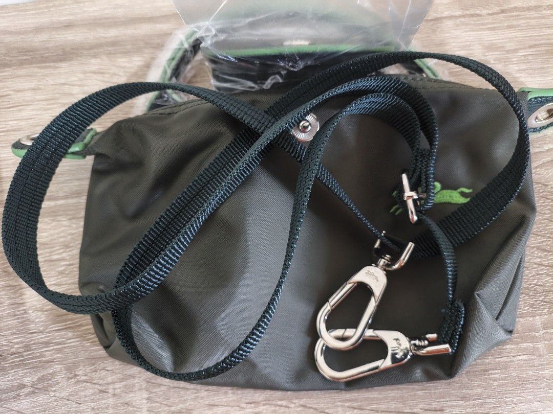 Longchamp Green Nylon Mini Top Handle Bag (Category: Luxury Bags & Wallets) located in Quezon City. Submitted by closeta38 (Listing ID 1468725165, Image 3). Description: - Brand: Longchamp - Color: Olive green nylon with dark green leather flap, handles, and strap - Condition: Brand new (handles still wrapped in protective plastic) - Hardware: Silver-tone with round metal zipper pull - Features: Iconic embroidered horse logo, secure zip closure, 