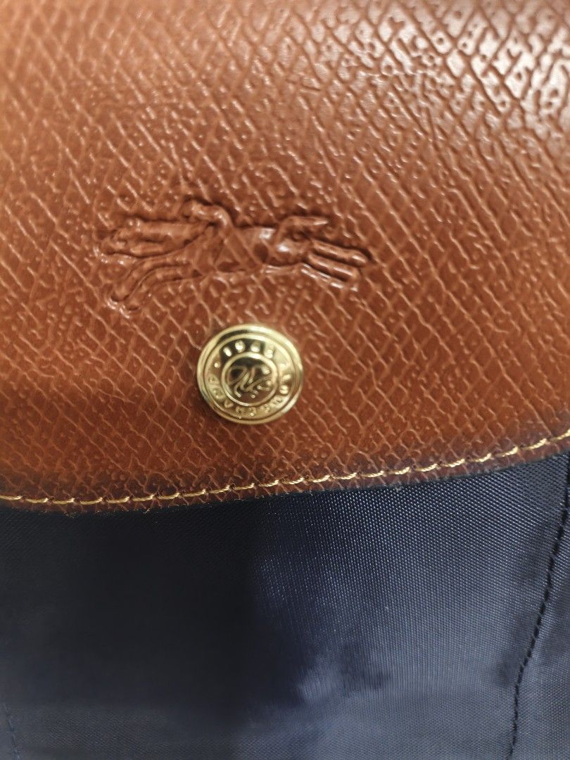 Longchamp Le Pliage Navy Nylon Tote Bag (Category: Luxury Bags & Wallets) located in Quezon City. Submitted by closeta38 (Listing ID 1468724901, Image 2). Description: - Longchamp Le Pliage Tote Bag - Color: Navy blue nylon with brown leather flap and handles - Hardware: Gold-tone with iconic horse logo and 1948 branding - Condition: Brand new, tag attached to side ring, handles still in original plastic packaging - Perfect for daily use, travel,