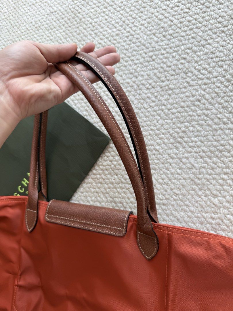 Longchamp Le Pliage Orange Shoulder Bag (Category: Luxury Bags & Wallets) located in Manila. Submitted by absndy (Listing ID 1468743051, Image 2). Description: FOR SALE: Selling Authentic Long Champ Le Pliage Large in Brique, I have also black. ☺️ ✔️ Lightly used 9.9/10 ✔️ Items are well-kept, and in great condition! ✔️ Comes with original pouch & paperbag ✔️ 4800 only RFS: Hindi na nagagamit. 📍Location: Manila Payment first only Lalamove & JNT 