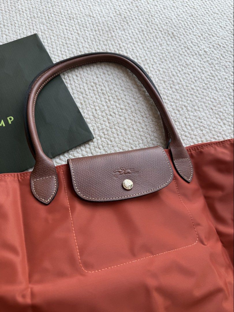 Longchamp Le Pliage Orange Shoulder Bag (Category: Luxury Bags & Wallets) located in Manila. Submitted by absndy (Listing ID 1468743051, Image 1). Description: FOR SALE: Selling Authentic Long Champ Le Pliage Large in Brique, I have also black. ☺️ ✔️ Lightly used 9.9/10 ✔️ Items are well-kept, and in great condition! ✔️ Comes with original pouch & paperbag ✔️ 4800 only RFS: Hindi na nagagamit. 📍Location: Manila Payment first only Lalamove & JNT 
