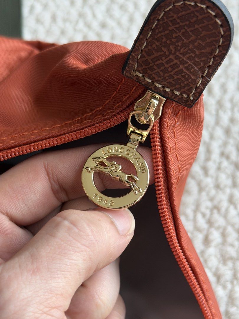 Longchamp Le Pliage Orange Shoulder Bag (Category: Luxury Bags & Wallets) located in Manila. Submitted by absndy (Listing ID 1468743051, Image 3). Description: FOR SALE: Selling Authentic Long Champ Le Pliage Large in Brique, I have also black. ☺️ ✔️ Lightly used 9.9/10 ✔️ Items are well-kept, and in great condition! ✔️ Comes with original pouch & paperbag ✔️ 4800 only RFS: Hindi na nagagamit. 📍Location: Manila Payment first only Lalamove & JNT 