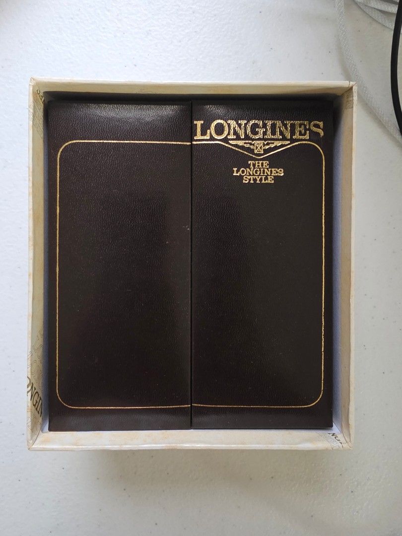 Longines Vintage Watch Presentation Box with Outer Box (Category: Luxury Watches) located in Malolos. Submitted by 888collectibles (Listing ID 1468801081, Image 1). Description: - 100% Authentic Longines watch storage box and outer packaging for 70s and 80s - Deep brown faux leather finish with elegant gold lettering and trim - Luxurious beige velvet interior lining with a removable watch pillow cushion - Includes matching outer cardboard box fea