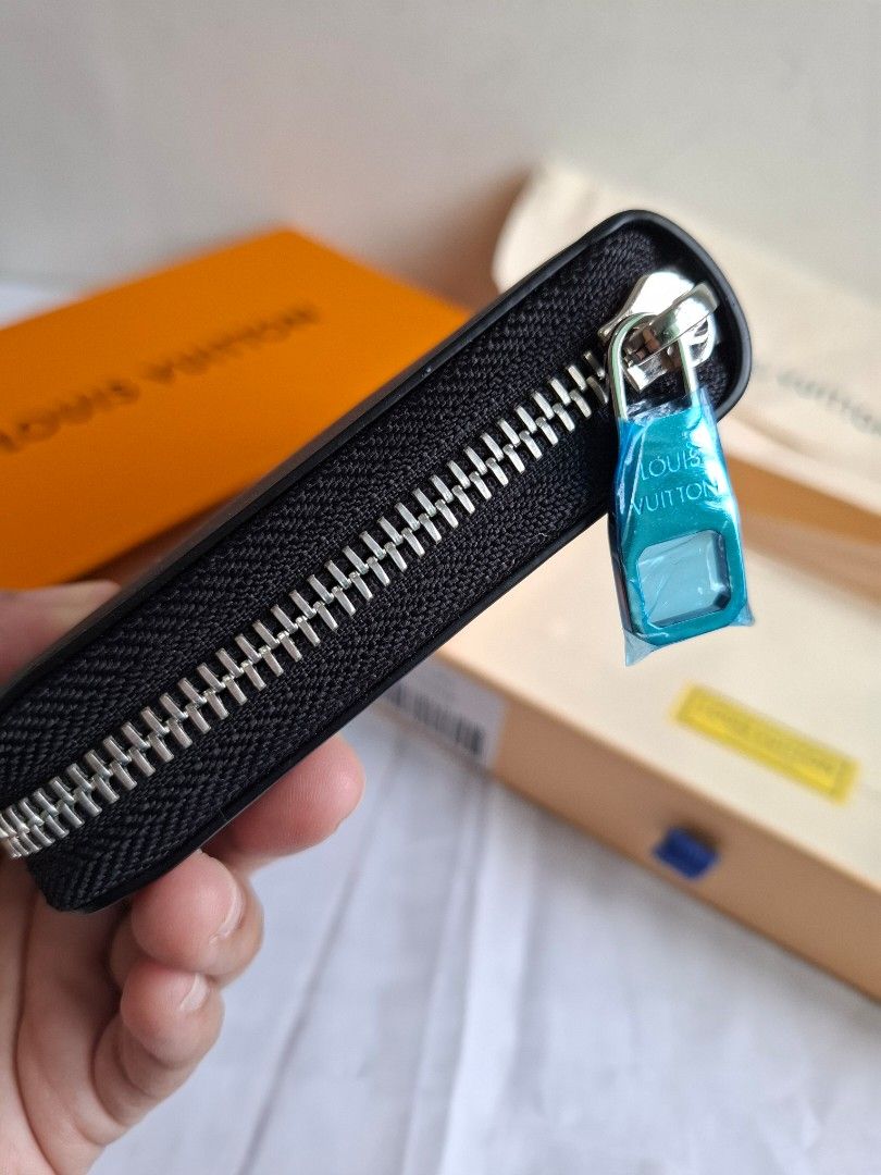 Louis Vuitton Black Monogram Zipped Wallet Box Set (Category: Luxury Bags & Wallets) located in Muntinlupa City. Submitted by iaramos (Listing ID 1468867717, Image 3). Description: - Style: Long zip-around wallet - Design: Black with scattered white LV monogram symbols and silver-tone hardware - Interior: Multiple card slots, spacious compartments, and a secure zippered coin pocket - Condition: Brand new, protective plastic wrap still attached to