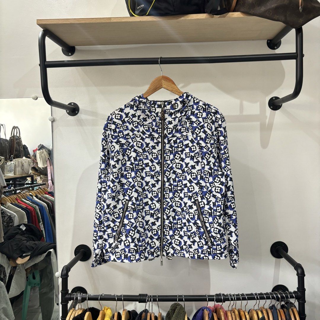 Louis Vuitton Blue White Monogram Windbreaker Jacket (Category: Coats, Jackets and Outerwear) located in Bambang. Submitted by heats777 (Listing ID 1468827930, Image 2). Description: - Stylish all-over monogram pattern in blue, white, and black - Hooded windbreaker design with a full zip front - Premium monogram leather zip pull and branded metal hardware - Convenient zippered side pockets for your essentials - Lightweight fabric that is easy to 