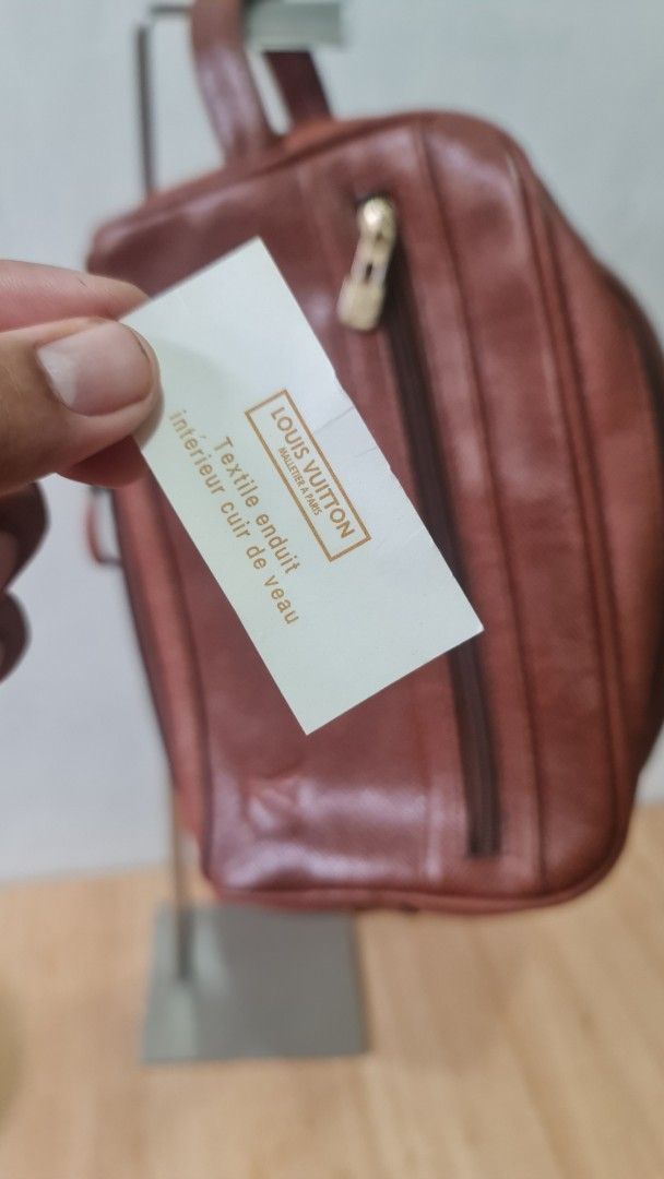 Louis Vuitton Brown Leather Pouch (Category: Luxury Bags & Wallets) located in Caloocan City. Submitted by royaldragon_d59aba (Listing ID 1468757141, Image 1). Description: - Brand: Louis Vuitton - Color/Material: Brown textured leather and coated textile - Closures: Secure double zip top closure plus an extra side zipped pocket - Handle: Small leather loop handle on the slider for easy carrying - Interior: Premium calf leather lining.