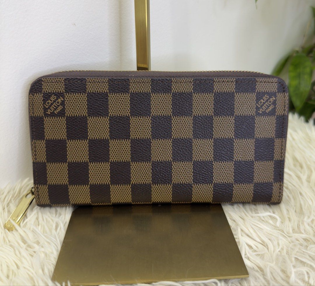 Louis Vuitton Damier Ebene Zippy Wallet (Category: Luxury Bags & Wallets) located in Consolacion. Submitted by naome1. (Listing ID 1468877290, Image 1). Description: - Authentic qualy Louis Vuitton Zippy Wallet in Damier Ebene canvas bale from japan - Classic brown checkered pattern with polished gold-tone hardware - Secure zip-around closure with a smooth-running zipper - Clean interior and exterior - Features multiple card slots, bill compartme