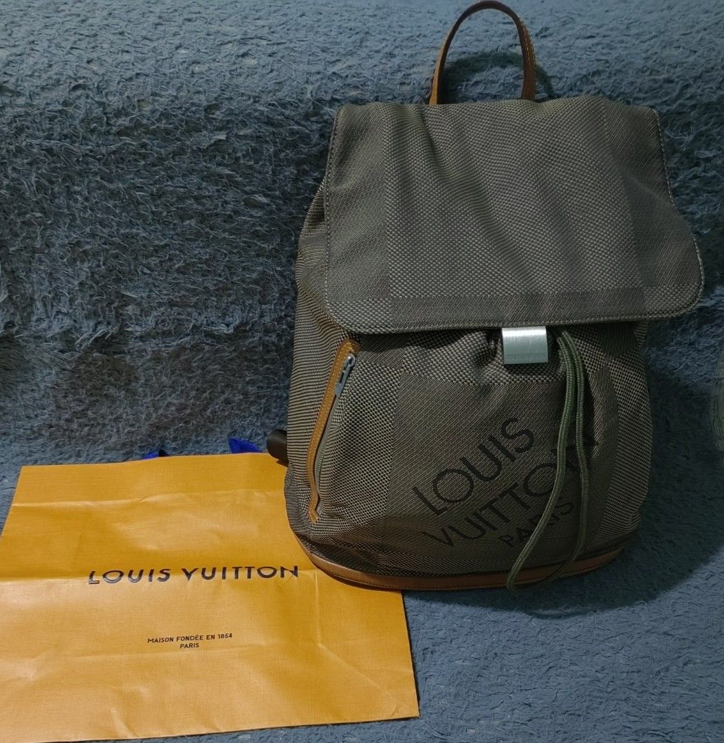 Louis Vuitton Green Monogram Mini Lin Canvas Backpack (Category: Backpacks) located in Las Pinas. Submitted by huslerz (Listing ID 1468818162, Image 1). Description: - Louis Vuitton mini lin canvas backpack in olive green - Bold large printed logo on the front pocket - Secure drawstring closure with flap top and metal clasp buckle - Convenient side zip pocket with branded hardware - Premium tan leather trim and sturdy top handle - Comes with an o