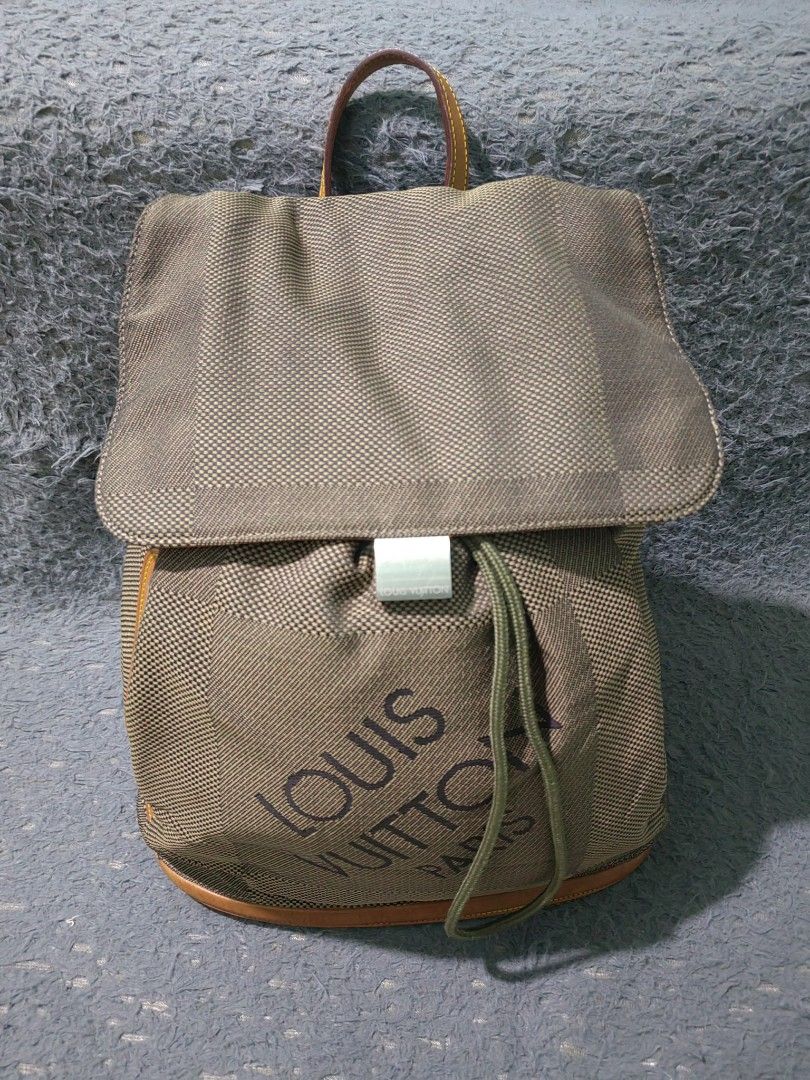 Louis Vuitton Green Monogram Mini Lin Canvas Backpack (Category: Backpacks) located in Las Pinas. Submitted by huslerz (Listing ID 1468818162, Image 2). Description: - Louis Vuitton mini lin canvas backpack in olive green - Bold large printed logo on the front pocket - Secure drawstring closure with flap top and metal clasp buckle - Convenient side zip pocket with branded hardware - Premium tan leather trim and sturdy top handle - Comes with an o