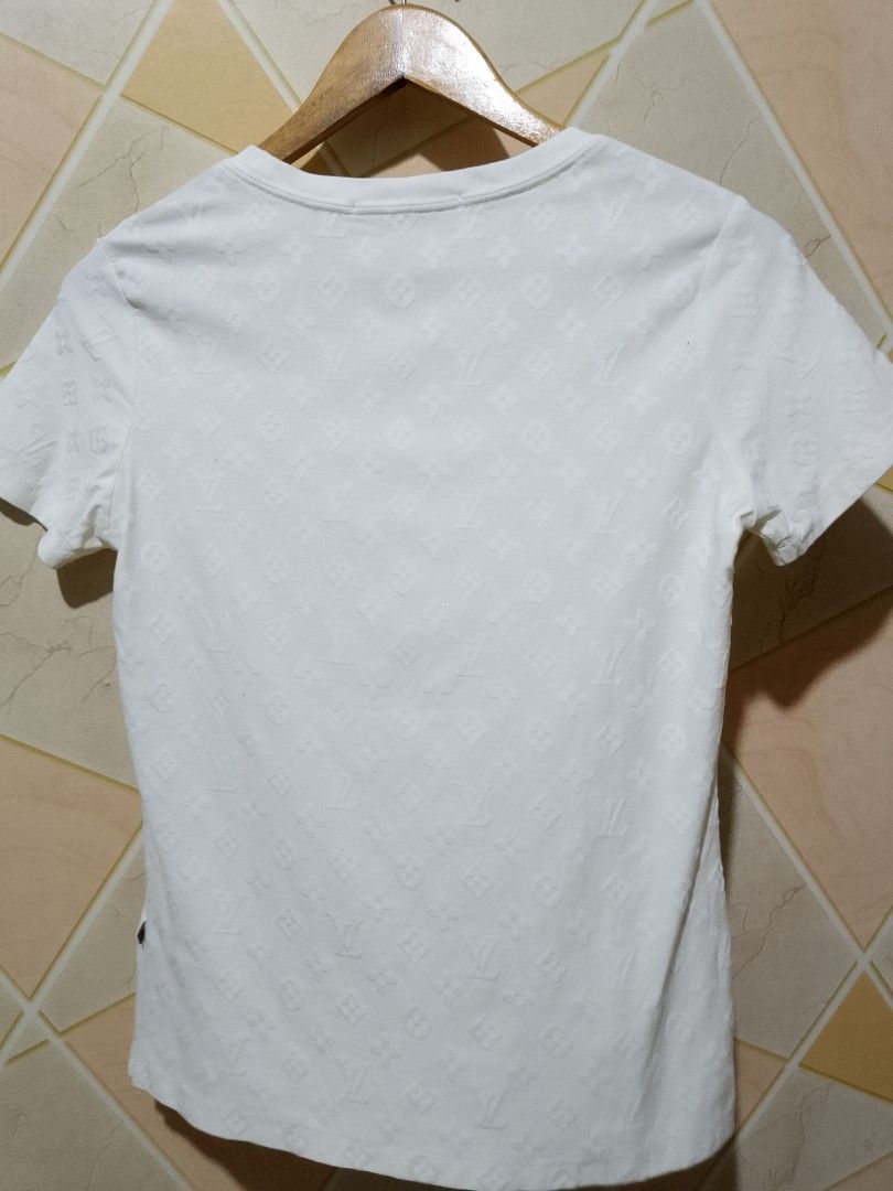 Louis Vuitton Monogram Embossed White T-shirt Size S (Category: Shirts) located in San Pedro. Submitted by jokwanrocks09 (Listing ID 1468808308, Image 2). Description: Louis Vuitton white crew neck tee. Monogram pattern all over, subtle embossed texture in the fabric. Short sleeves, standard fit. Size S tag inside. Made in Italy. Gentle dry clean recommended, wash inside out in a net. Clean condition, no stains or damage found during inspection. 
