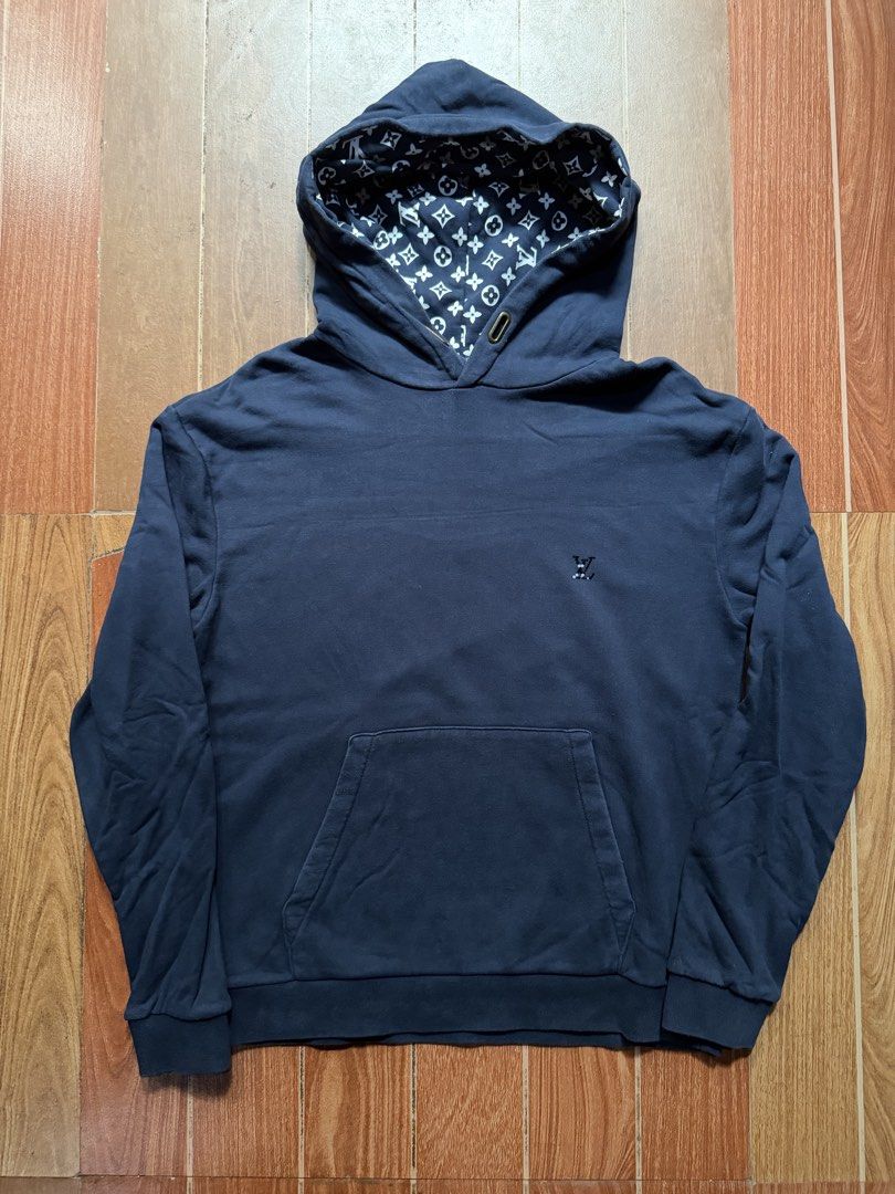 Louis Vuitton Monogram Hooded Sweatshirt Navy Blue (Category: Coats, Jackets and Outerwear) located in Dasmarinas. Submitted by kylebecker (Listing ID 1468927342, Image 1). Description: - Color: Dark blue - Material: Comfortable cotton blend fabric - Design: Front kangaroo pocket, standard drawstring hood - Details: Features LV monogram printed pattern inside the hood lining - Branding: Small embroidered LV logo on the chest - Fit: Ribbed cuffs a