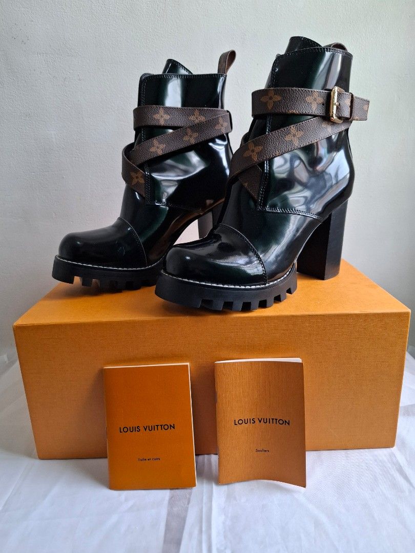 Louis Vuitton Monogram Patent Leather Boots (Category: Boots) located in Muntinlupa City. Submitted by iaramos (Listing ID 1468865355, Image 1). Description: - Brand: Louis Vuitton - Style: Patent leather boots with chunky block heels and lug soles - Details: Iconic monogram canvas crossover straps with gold-tone buckle hardware - Condition: Clean uppers and pristine soles, ready to wear - Inclusions: Original orange box, dust bags, and booklets 
