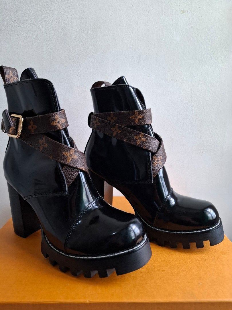 Louis Vuitton Monogram Patent Leather Boots (Category: Boots) located in Muntinlupa City. Submitted by iaramos (Listing ID 1468865355, Image 3). Description: - Brand: Louis Vuitton - Style: Patent leather boots with chunky block heels and lug soles - Details: Iconic monogram canvas crossover straps with gold-tone buckle hardware - Condition: Clean uppers and pristine soles, ready to wear - Inclusions: Original orange box, dust bags, and booklets 