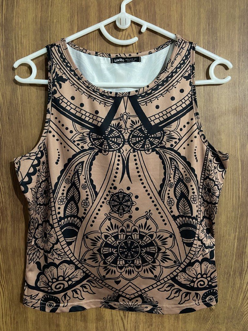 Lovito Sleeveless Tank Top (Category: Sleeveless) located in Caloocan City. Submitted by lovedbyryu (Listing ID 1468845013, Image 1). Description: - Brand: Lovito - Size: M - Color: Beige with intricate black mandala and floral print - Design: Scoop neckline with white inner lining, sleeveless - Material: Soft and lightweight - Styling: Easy to pair with high-waisted jeans or shorts.