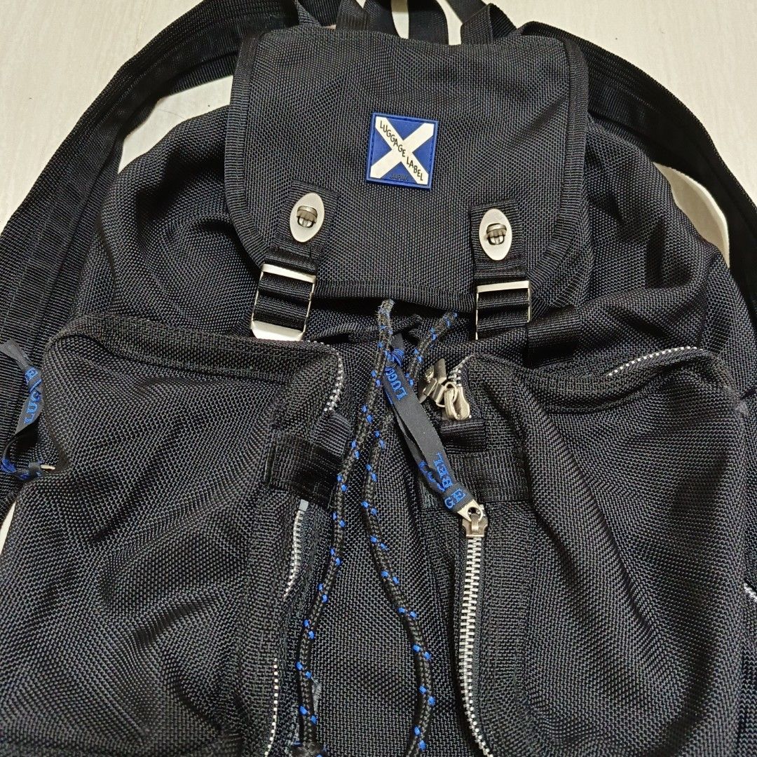 Luggage Label Backpack Black (Category: Backpacks) located in Nasugbu. Submitted by staffpicks1515 (Listing ID 1468785276, Image 2). Description: - Brand: Luggage Label - Color: Classic Black - Material: Heavy-duty woven nylon fabric - Closure: Front flap with double metal twist-lock clasps - Pockets: Twin front zipped utility pockets with braided zipper pulls - Hardware: Durable YKK zippers with custom hardware - Straps: Adjustable shoulder stra