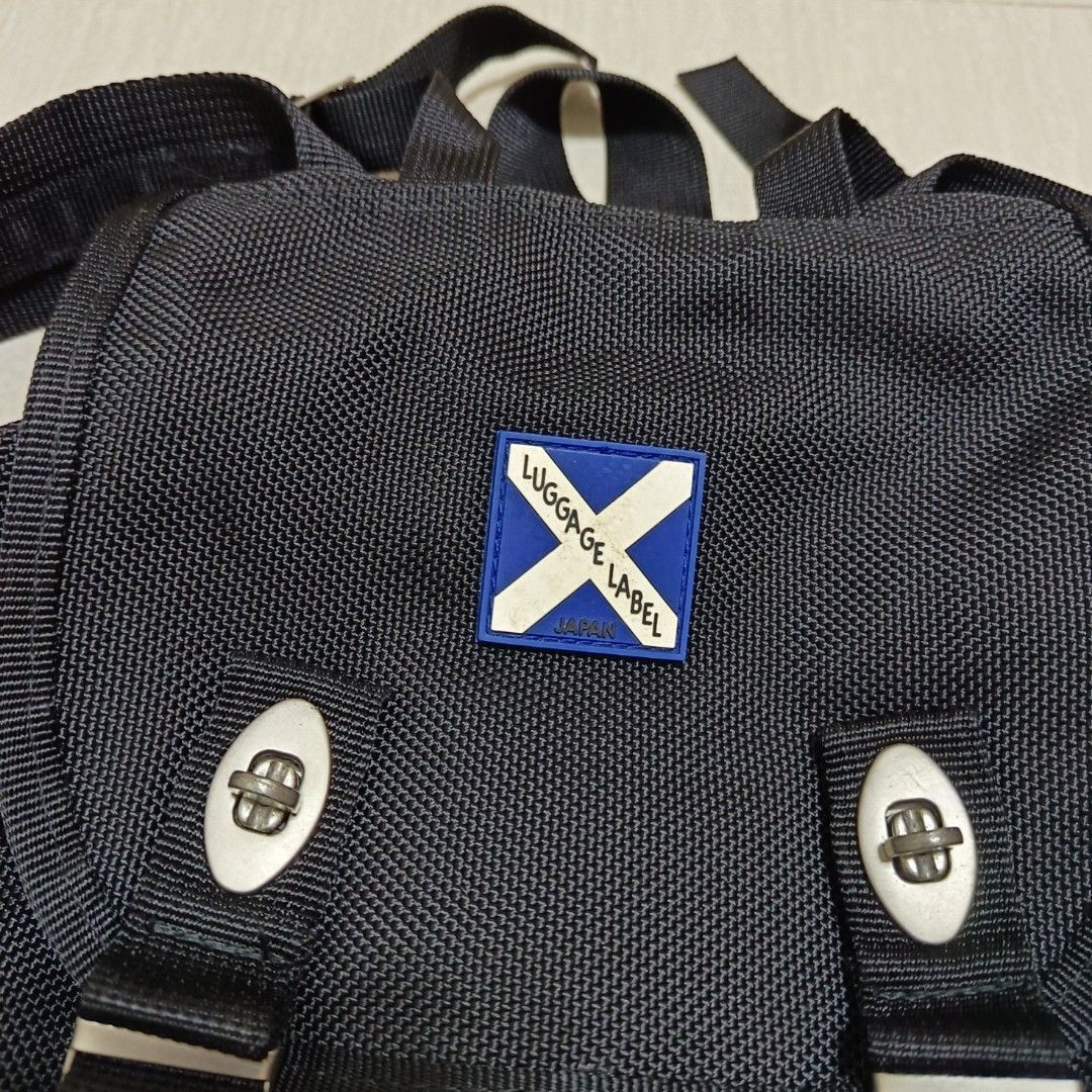 Luggage Label Backpack Black (Category: Backpacks) located in Nasugbu. Submitted by staffpicks1515 (Listing ID 1468785276, Image 3). Description: - Brand: Luggage Label - Color: Classic Black - Material: Heavy-duty woven nylon fabric - Closure: Front flap with double metal twist-lock clasps - Pockets: Twin front zipped utility pockets with braided zipper pulls - Hardware: Durable YKK zippers with custom hardware - Straps: Adjustable shoulder stra