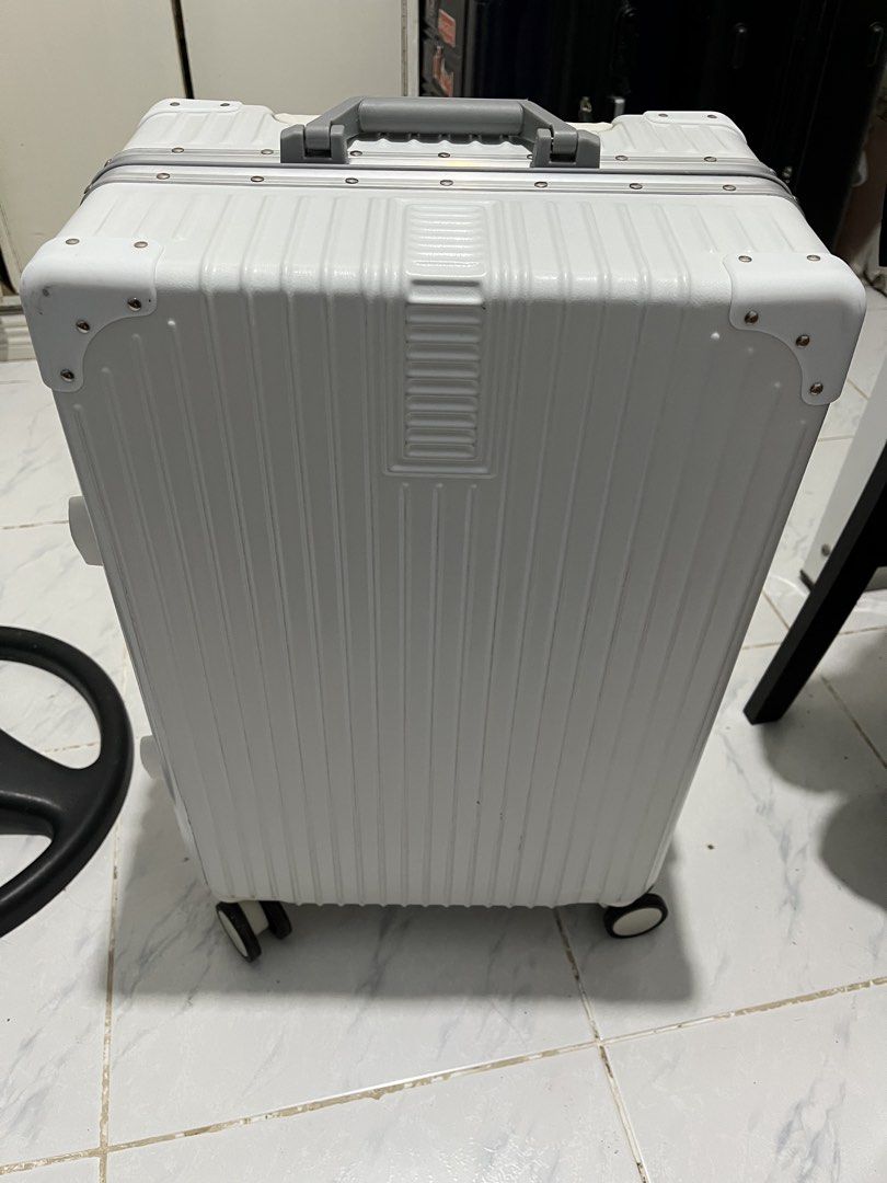 Luggage white (Category: Luggage) located in Marikina City. Submitted by patpatndls (Listing ID 1468907010, Image 1). Description: - Color: Clean White - Type: Hardcase luggage with sturdy aluminum frame and protective corner guards - Security: Dual combination locks for enhanced safety - Interior: Spacious black lining with zippered mesh compartments and cross-straps to secure belongings - Wheels & Handle: Smooth-rolling wheels and comfortable t