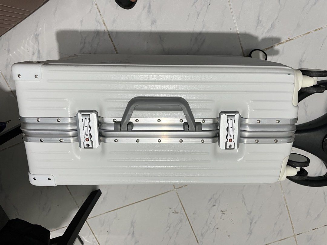 Luggage white (Category: Luggage) located in Marikina City. Submitted by patpatndls (Listing ID 1468907010, Image 3). Description: - Color: Clean White - Type: Hardcase luggage with sturdy aluminum frame and protective corner guards - Security: Dual combination locks for enhanced safety - Interior: Spacious black lining with zippered mesh compartments and cross-straps to secure belongings - Wheels & Handle: Smooth-rolling wheels and comfortable t