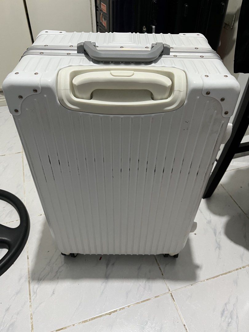 Luggage white (Category: Luggage) located in Marikina City. Submitted by patpatndls (Listing ID 1468907010, Image 2). Description: - Color: Clean White - Type: Hardcase luggage with sturdy aluminum frame and protective corner guards - Security: Dual combination locks for enhanced safety - Interior: Spacious black lining with zippered mesh compartments and cross-straps to secure belongings - Wheels & Handle: Smooth-rolling wheels and comfortable t