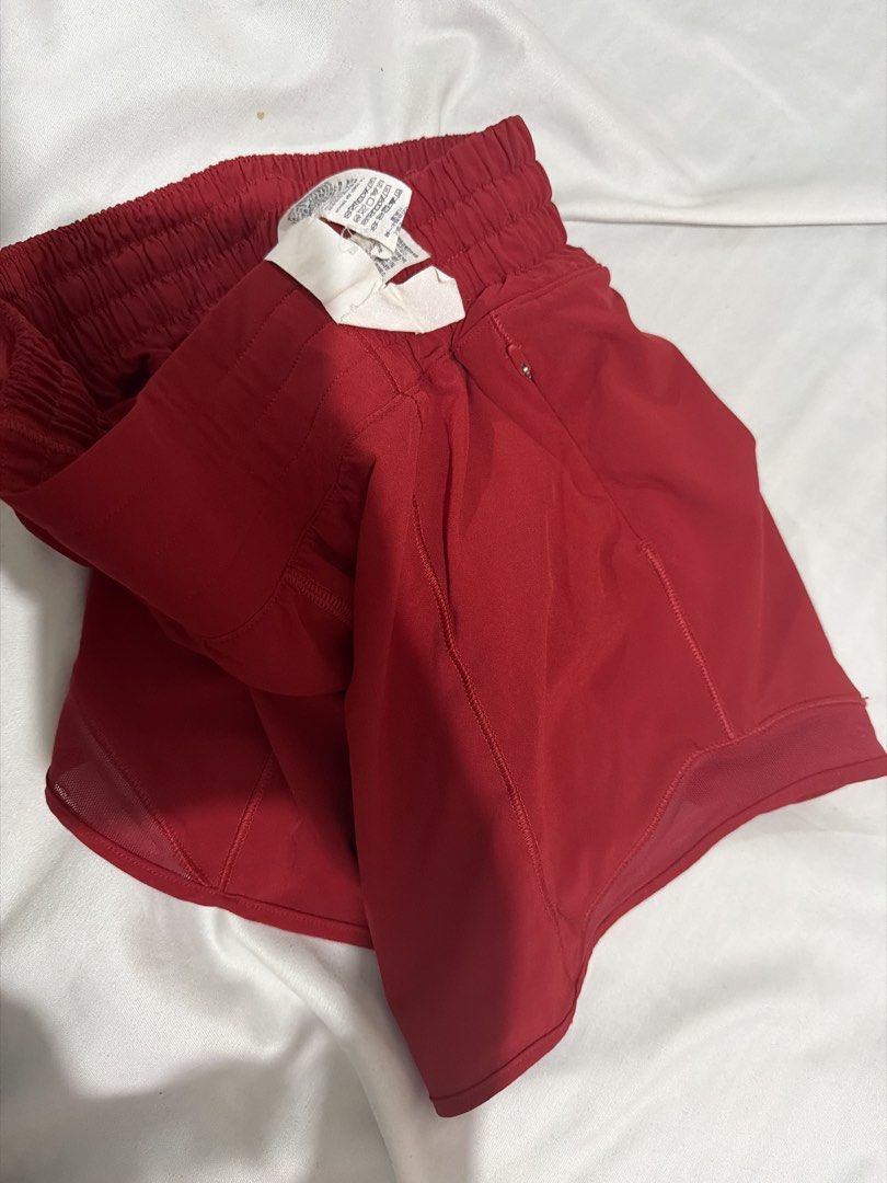 Lululemon Athletic Shorts Size 2 Red (Category: Shorts) located in Pasay City. Submitted by gold1001 (Listing ID 1468808311, Image 3). Description: - Brand: Lululemon - Color: Vibrant Red - Size: 2 - Material: Lightweight, breathable fabric ideal for runs and workouts - Features: Elastic waistband with drawstring loop and built-in liner - Details: Clean inner tag and clear logo on the leg hem - Condition: Excellent, ready to wear.